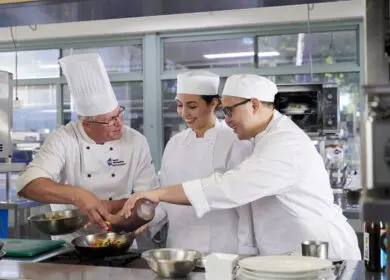 International students learning to cook a stir-fry at Bentley Pines Training Restaurant, Perth